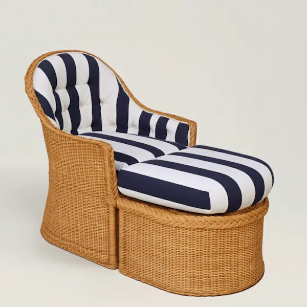 Amalfi wicker lounge chair and ottoman angled side view, bold navy striped cushions, handwoven honey wicker frame