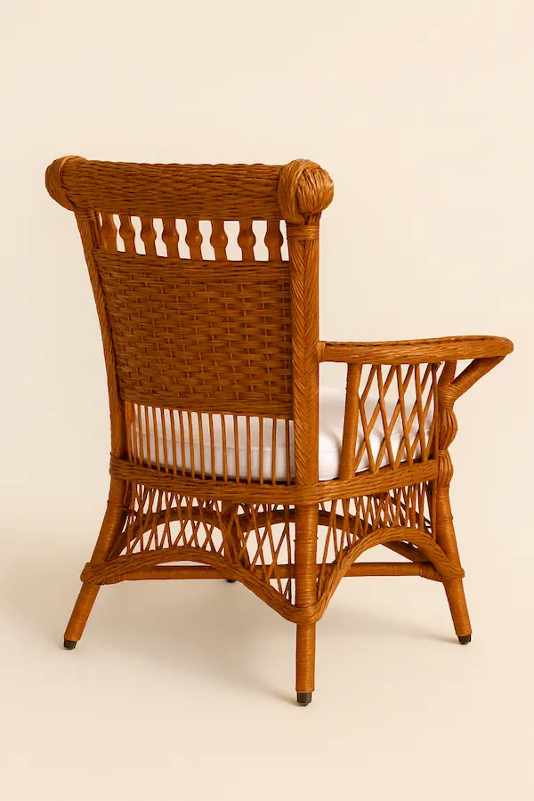 American Victorian Wicker Armchair Back View American Victorian Wicker Armchair, front view showcasing intricate wicker weave and white cushion