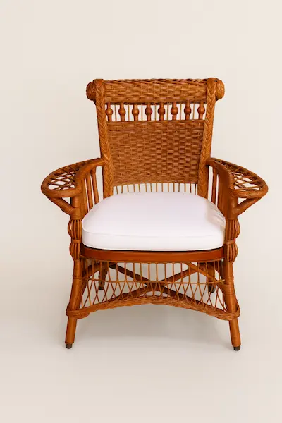 American Victorian Wicker ArmchairFront View merican Victorian Wicker Armchair, front view showcasing intricate wicker weave and white cushion