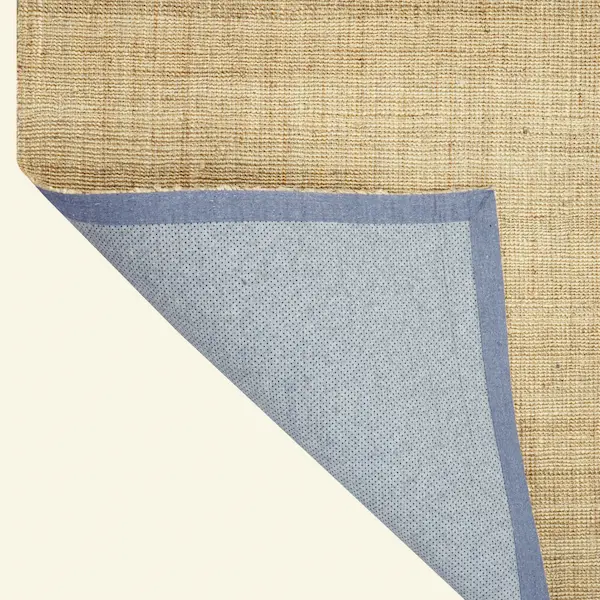 Dune Linen Weave Jute Rug – Corner Detail with Backing Corner detail of Dune Linen Weave Jute Rug showing hand-stitched edge and backing