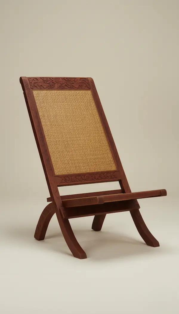 Maharaja Hand-Carved Folding Cane Chair – Mahogany Wood, Anglo-Indian Style Maharaja hand-carved Anglo-Indian folding chair in mahogany with woven cane seat and back, luxury heritage furniture.