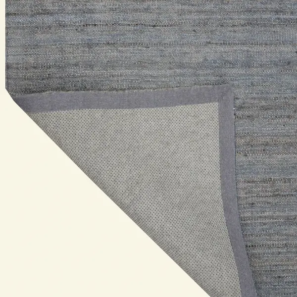 Slate Ridge Handwoven Jute Rug – Corner Fold Detail Corner fold detail of the Slate Ridge Handwoven Jute Rug with backing