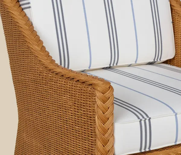 Close-up detail of Westport Wicker Lounge Chair showing handwoven wicker texture and striped cushion.