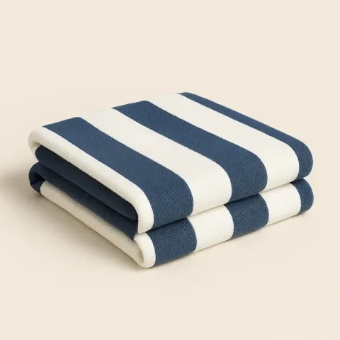 Blue and White Beach Blanket neatly folded with vertical woven stripes