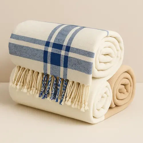 Blue and White Check Blanket stacked with other luxury cotton blankets
