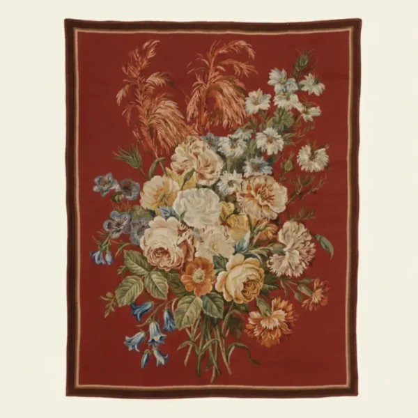 Hand-loomed Rosette Floral Wool Tapestry featuring a botanical bouquet of roses, carnations, and bluebells on a rich red background with a decorative border.