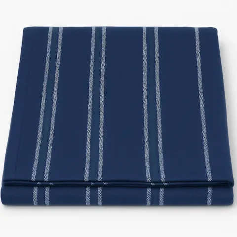 Folded woven stripe cotton blanket in navy with brushed finish, luxury textile