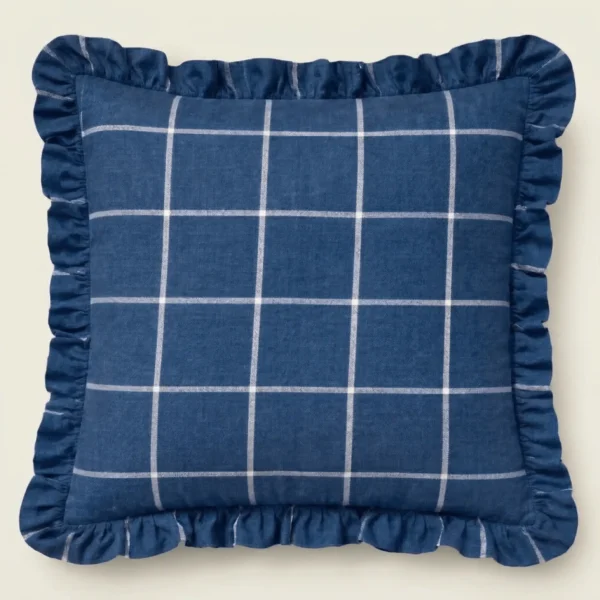 Navy linen throw pillow with ivory windowpane check and ruffle edge on neutral background