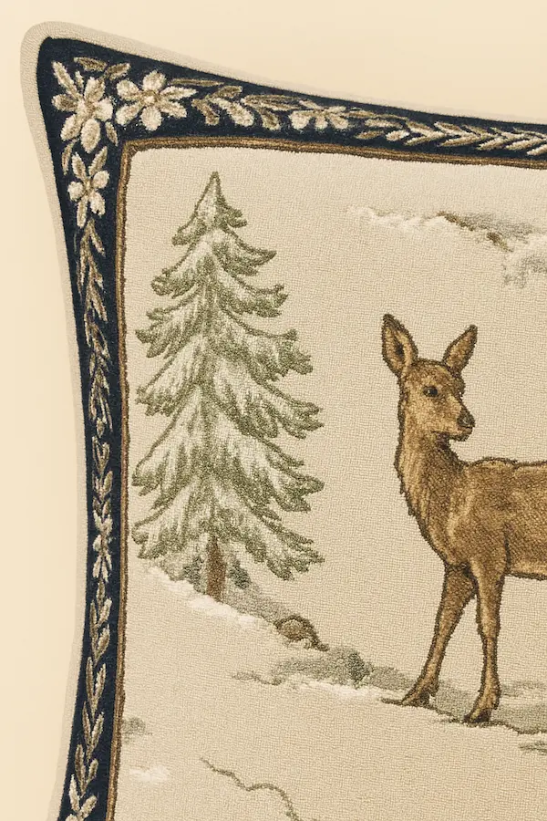 Close-up of Alpine Stag Tapestry Cushion corner showing stag and pine tree detail in tapestry weave.