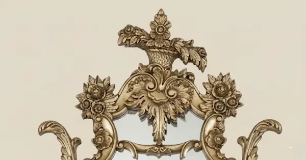 Close-up of hand-carved floral crest with hand-applied gold leaf on Beaumont Gilded Rococo Mirror