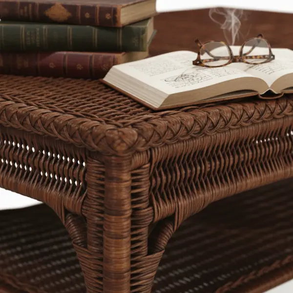 Sierra Woven Cocktail Table – Styled with Books and Glasses Close-up of Sierra Woven Cocktail Table with braided wicker trim, styled with books and glasses