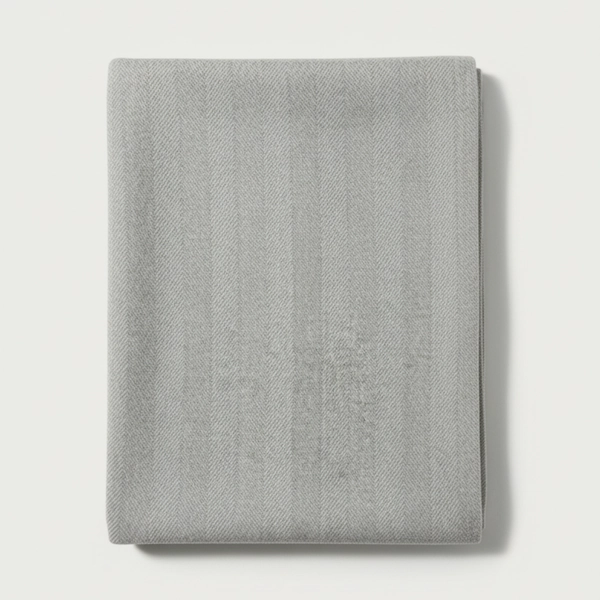 Marlowe Reversible Throw neatly folded to display its soft grey tone and subtle woven stripe variation.