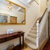 Luxurious grand entry foyer featuring elegant console table and ornate mirror