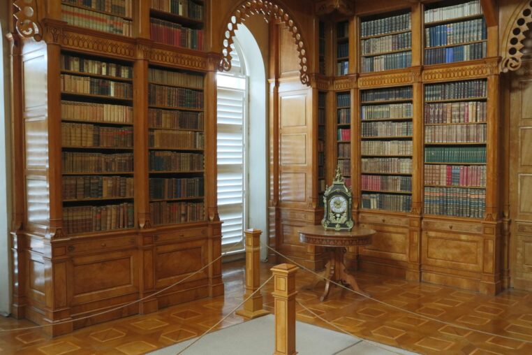 Elegant mahogany library bookcases filled with books in a traditional home setting