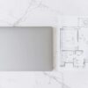Laptop and architectural floor plan on a clean desk for interior planning