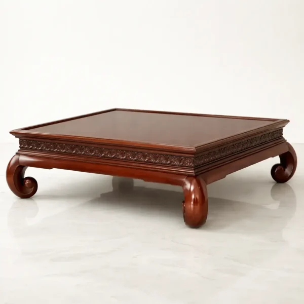 Large hand-carved solid mahogany low coffee table with bold scroll legs and swirl mahogany perimeter frame in Conservatory Garden finish.