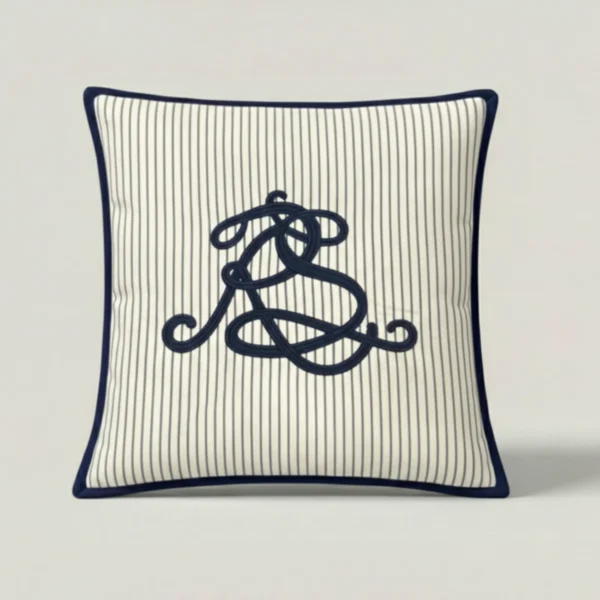 Mariner Script Stripe Throw Pillow in navy pinstripe cotton with embroidered script and contrast binding.
