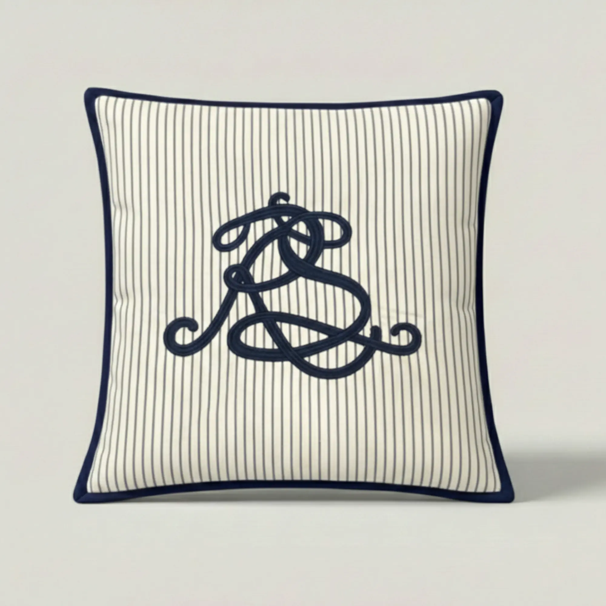 Mariner Script Stripe Throw Pillow in navy pinstripe cotton with embroidered script and contrast binding.