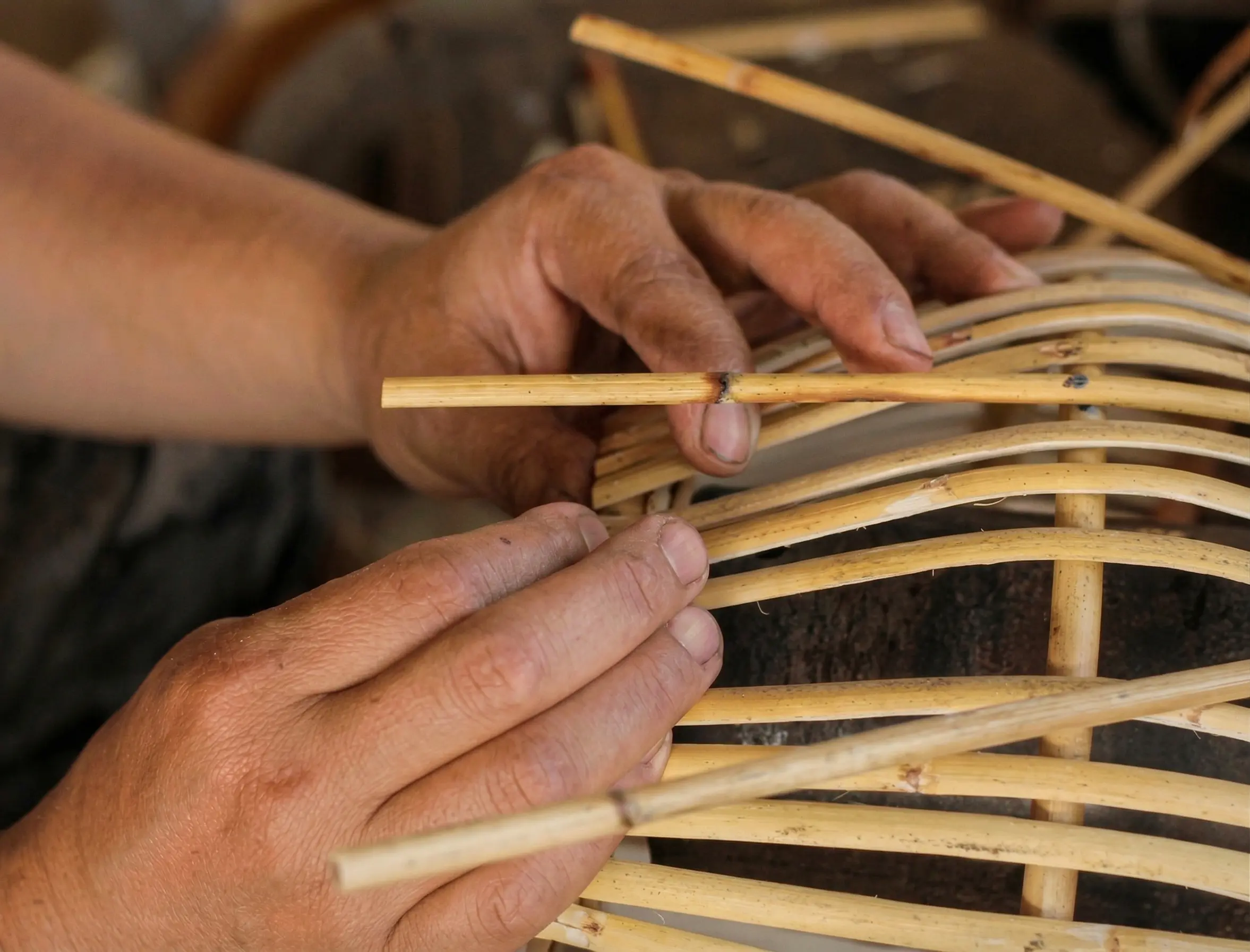 Hand weaving rattan showing fiber tension and structural pattern