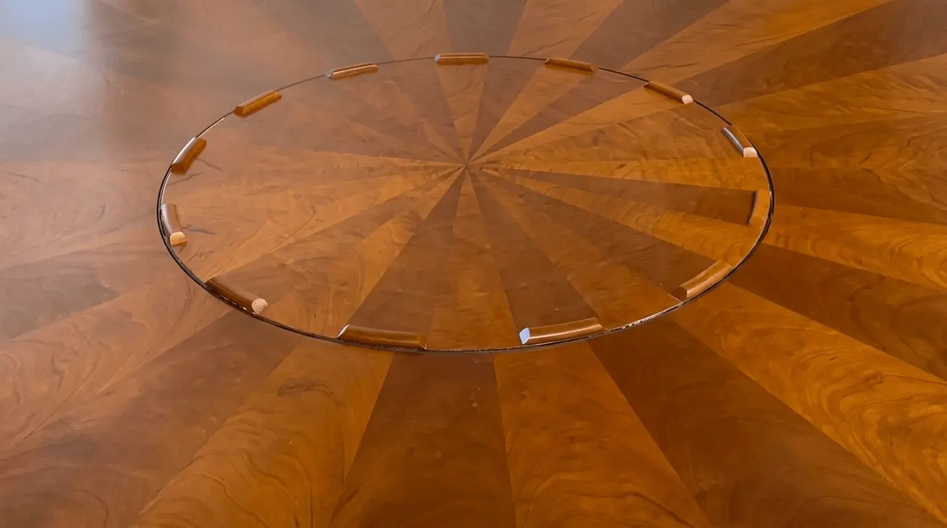 Radial veneer sunburst tabletop — grain direction shifts panel by panel