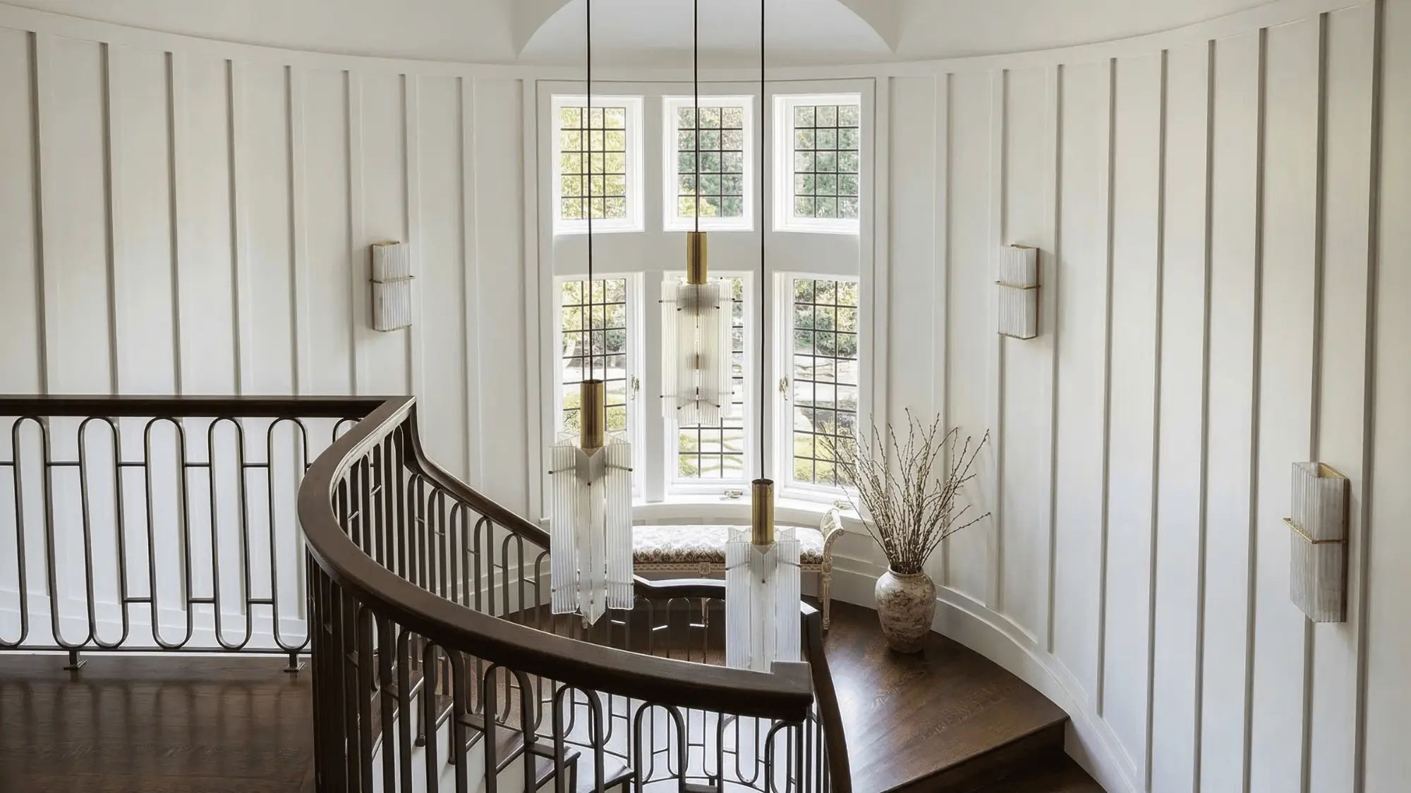 Curved staircase with natural light in architectural interior