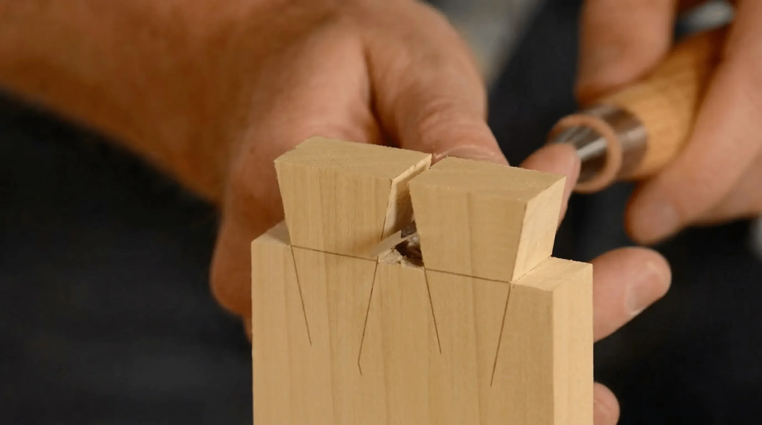 Hand-cut dovetail joinery detail in solid wood furniture