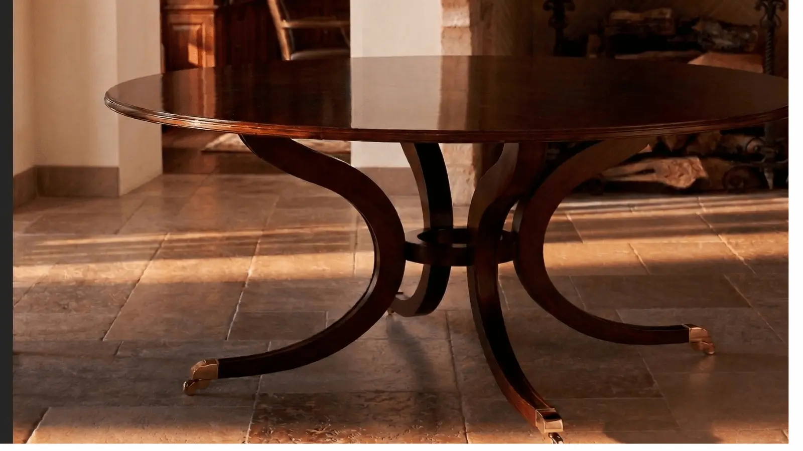 Round mahogany pedestal dining table detail in warm natural light