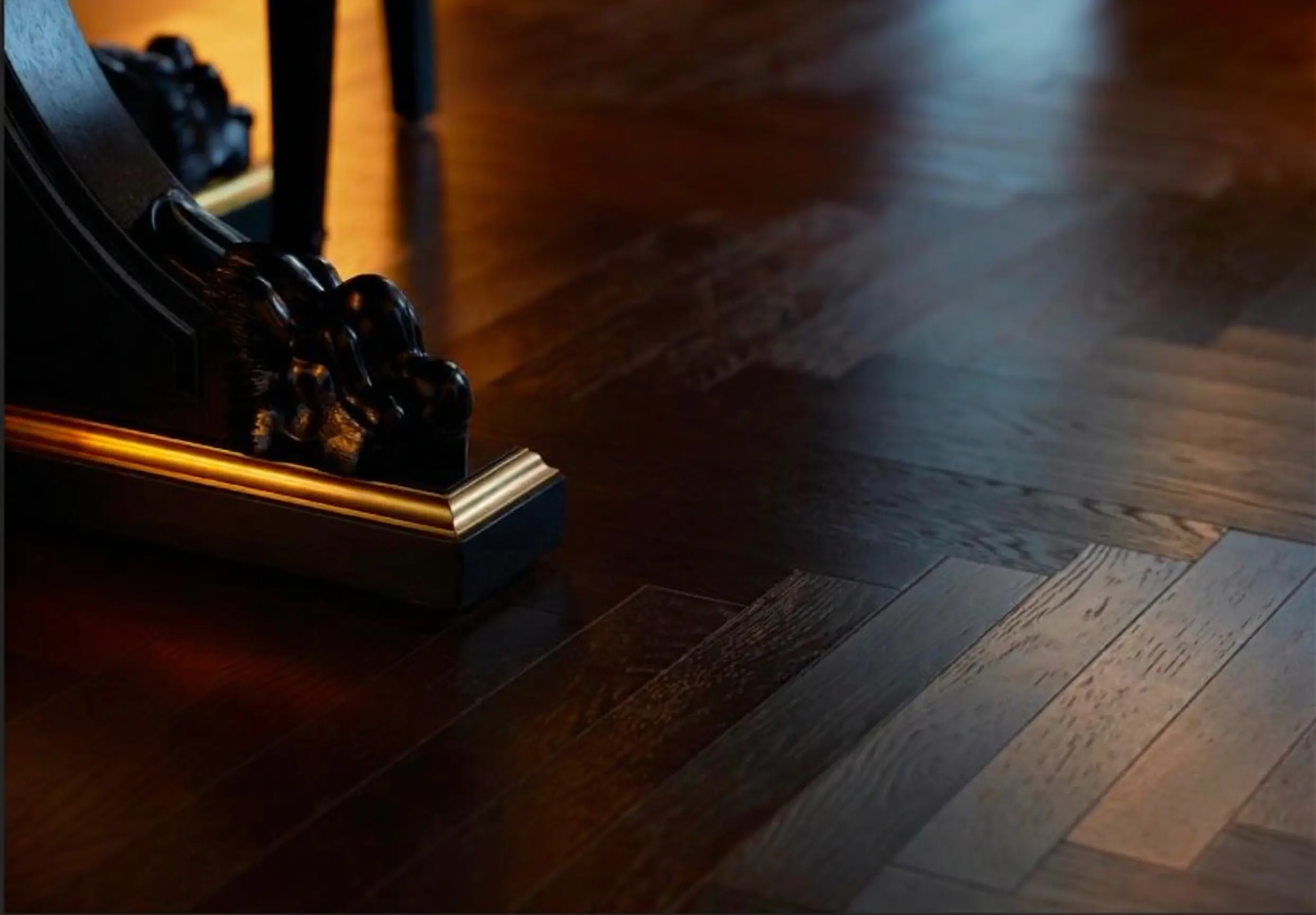 Close-up of wood grain and carved furniture base showing depth and finish