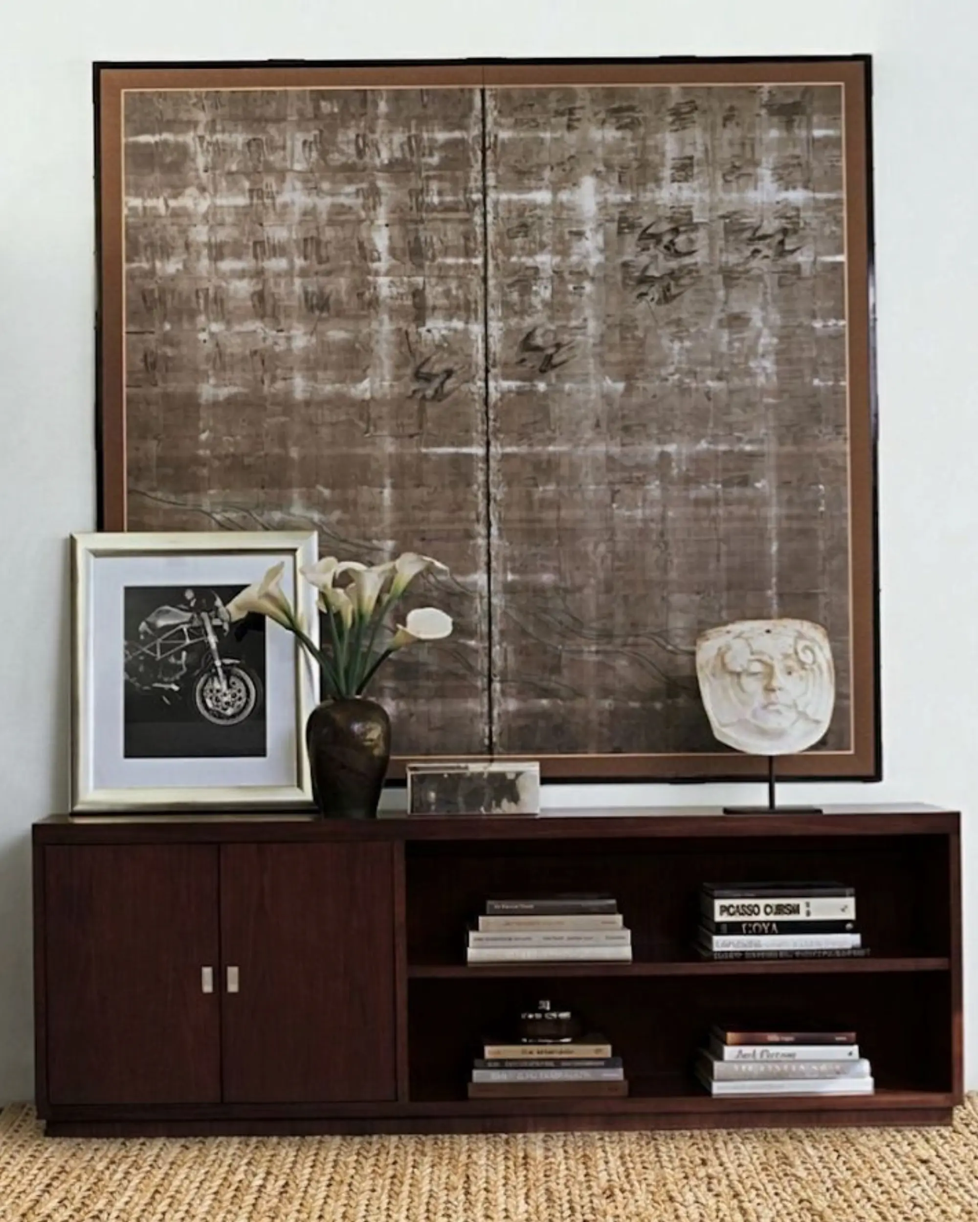 Mahogany console with jute rug showing grounded interior composition and material restraint