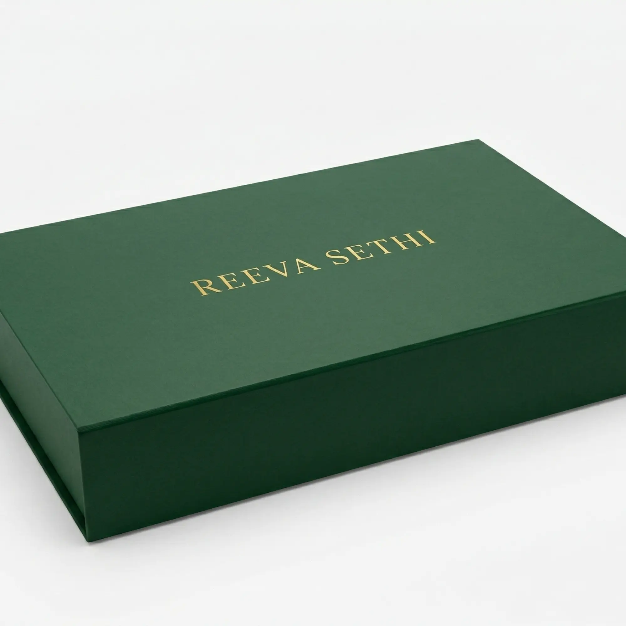 Closed green gift box with gold logo