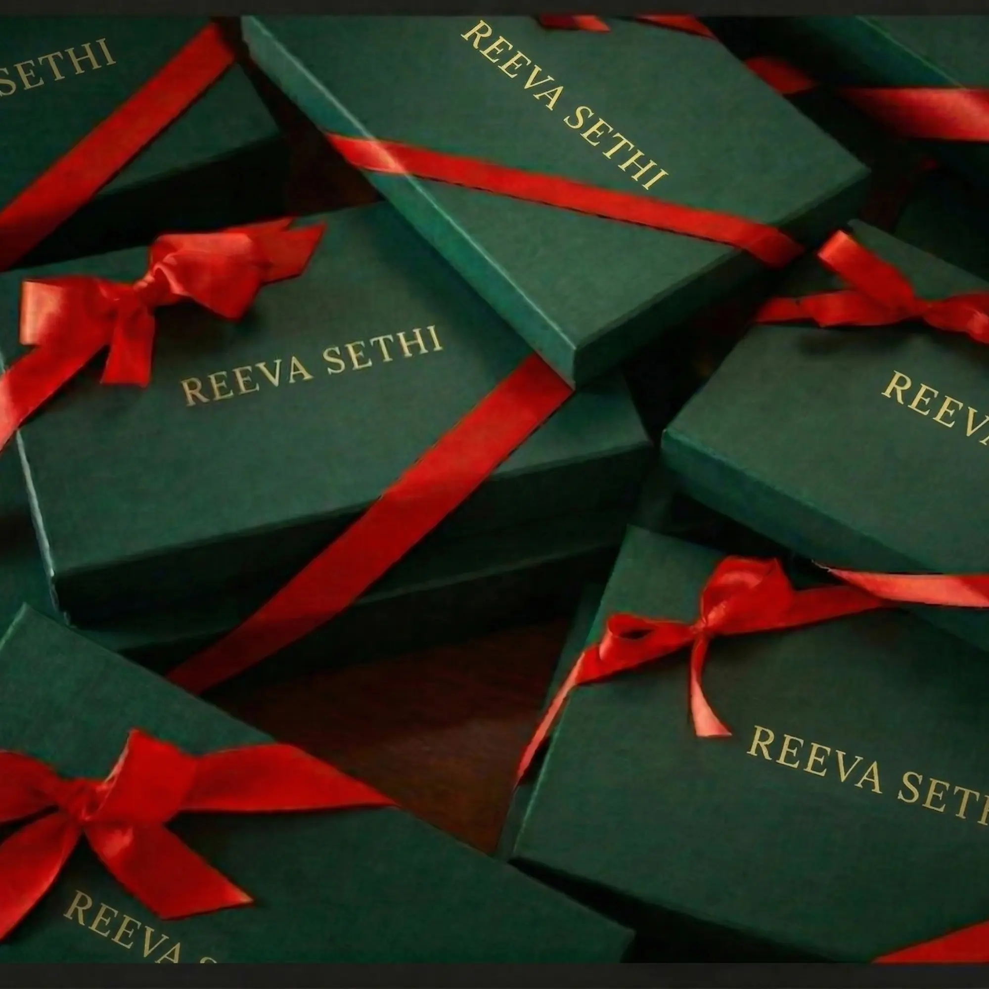 Luxury gift boxes in deep green with red ribbon