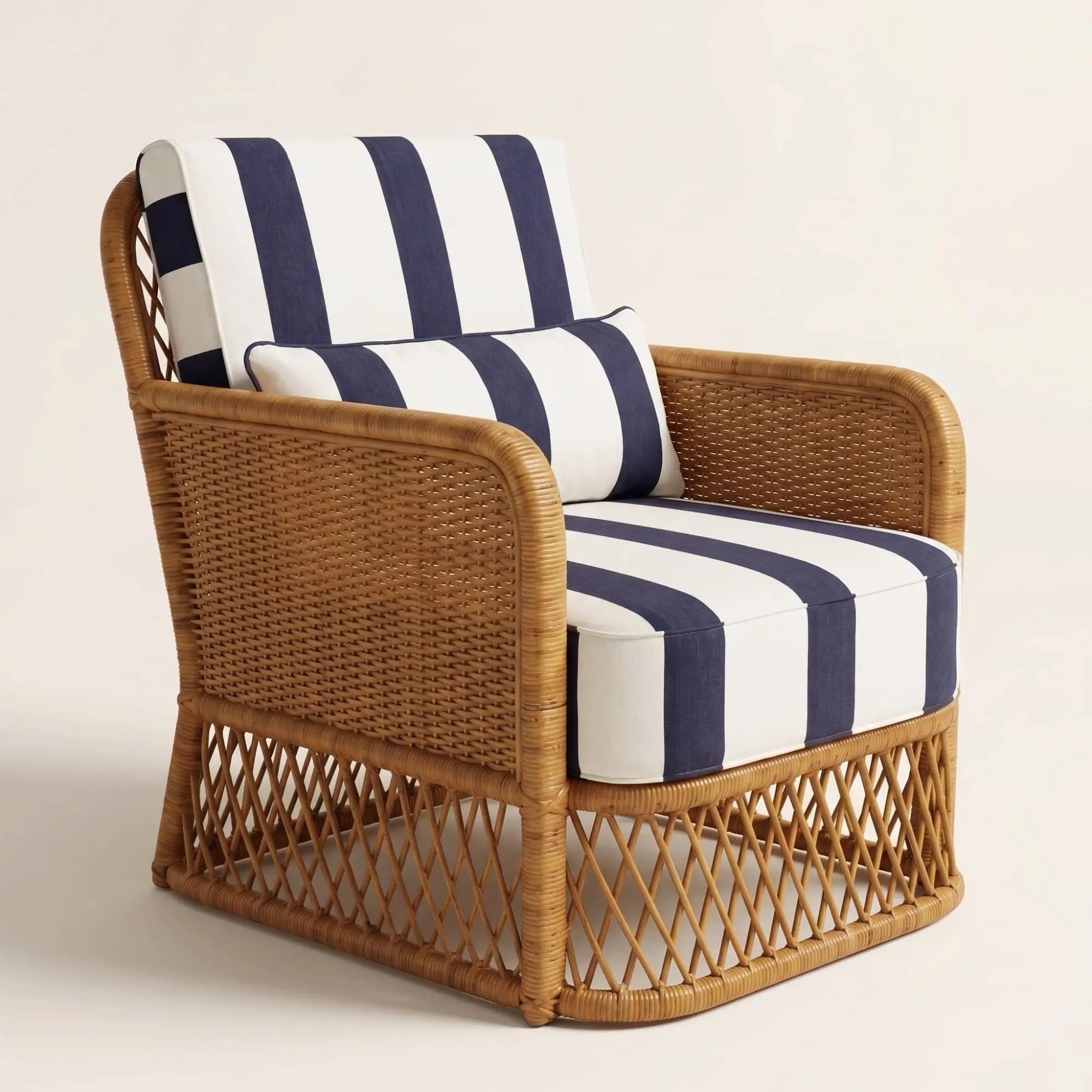 Montauk Cabana Lounge Chair 1 Montauk Cabana Lounge Chair with handwoven rattan frame and navy ivory striped cushions shown in front three-quarter view