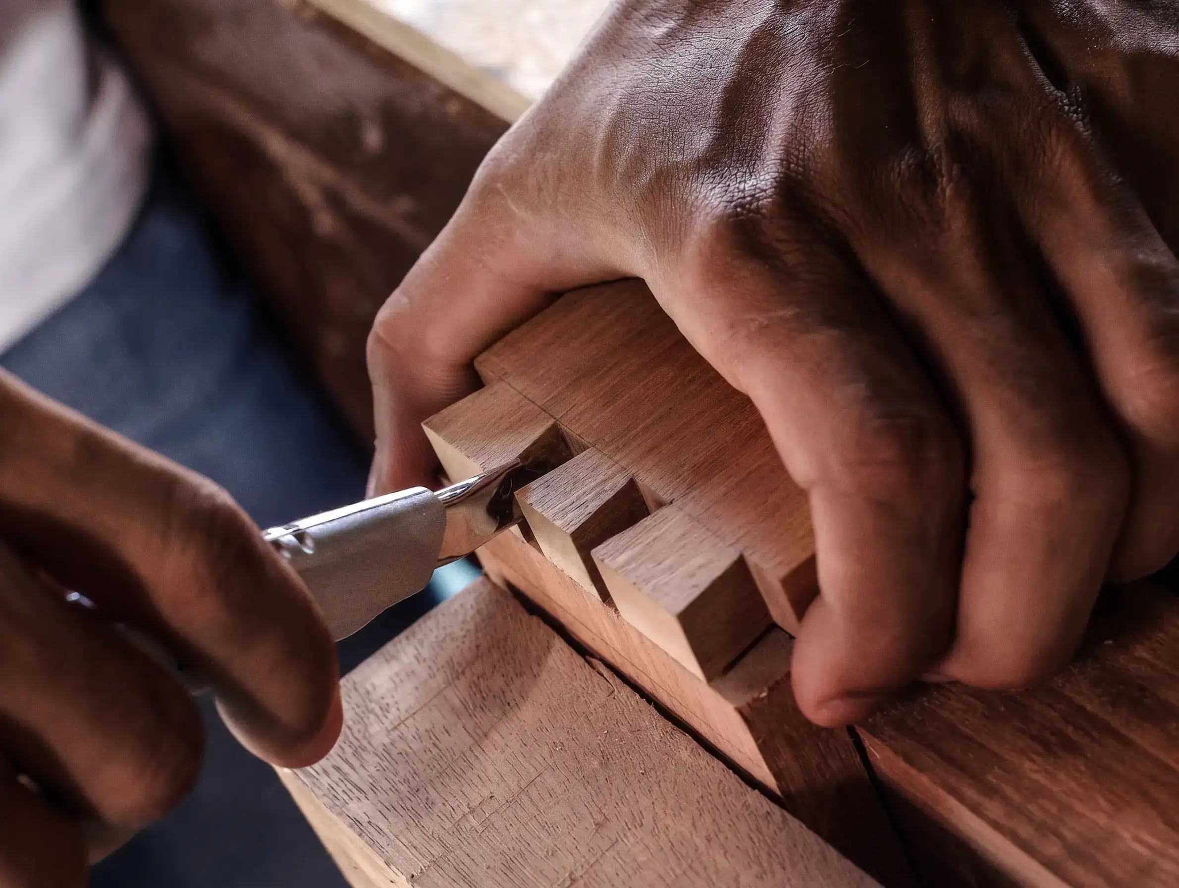 RS Studio 13 Craftsperson refining a traditional wood joint by hand — patronage and craftsmanship, RS Studio