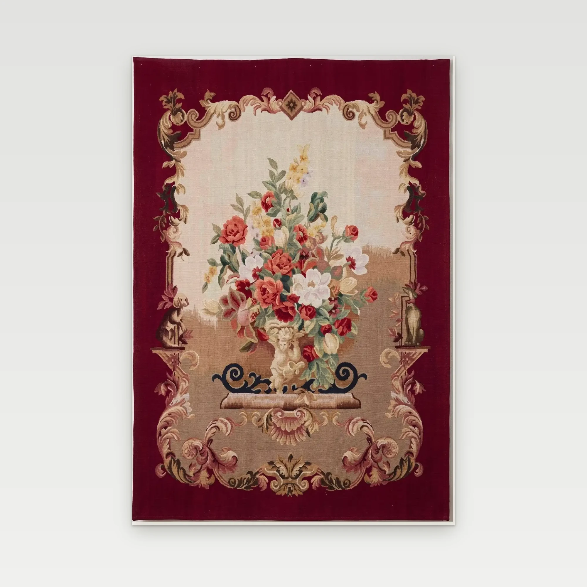 Burgundy Rose Urn Wall Tapestry 1 Burgundy Rose Urn handwoven wool tapestry with a cherub-held urn of roses in a cream and gold scrolled frame on a burgundy border