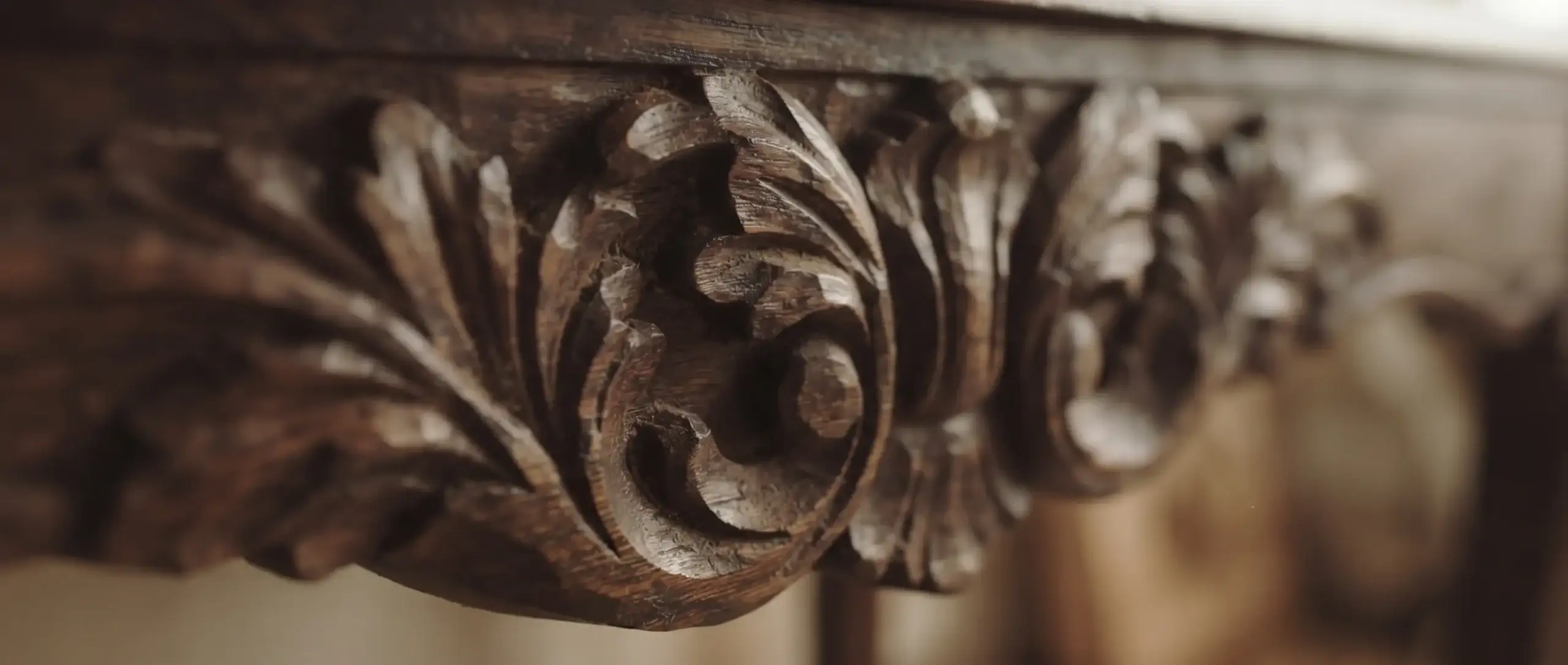 How to Tell If Furniture Is Well Made | A Field Guide to Craftsmanship 7 Close-up of hand-carved mahogany furniture detail with visible tool marks and layered leaf carving