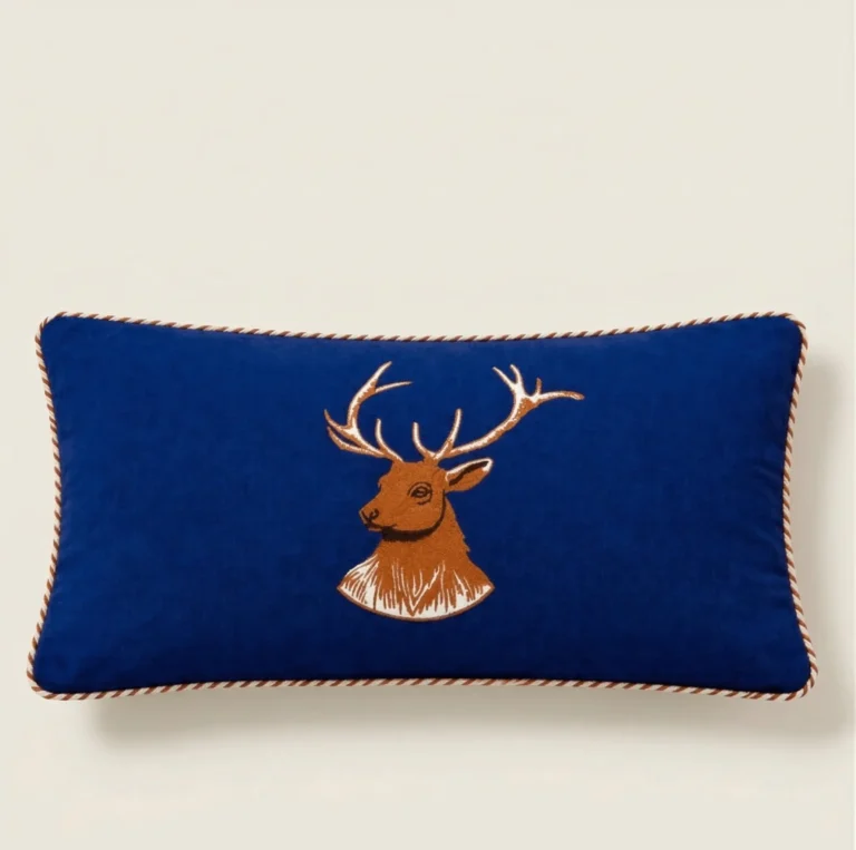 Navy lumbar pillow cover with embroidered stag design and piping