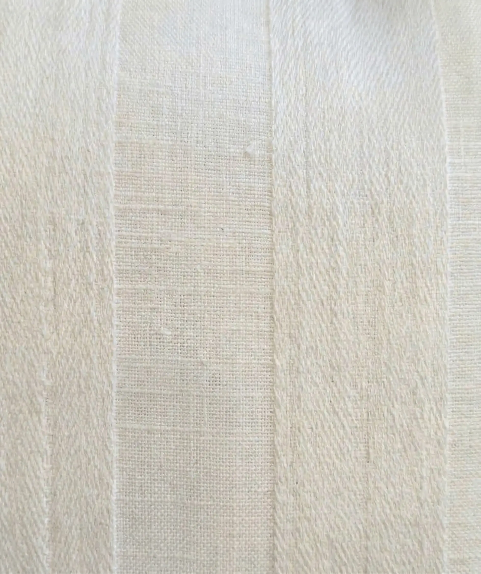 Langford Lumbar Pillow Cover 5 Vertical close-up of a cream-colored Langford lumbar pillow cover showing hand-woven linen texture and tonal herringbone stripes.