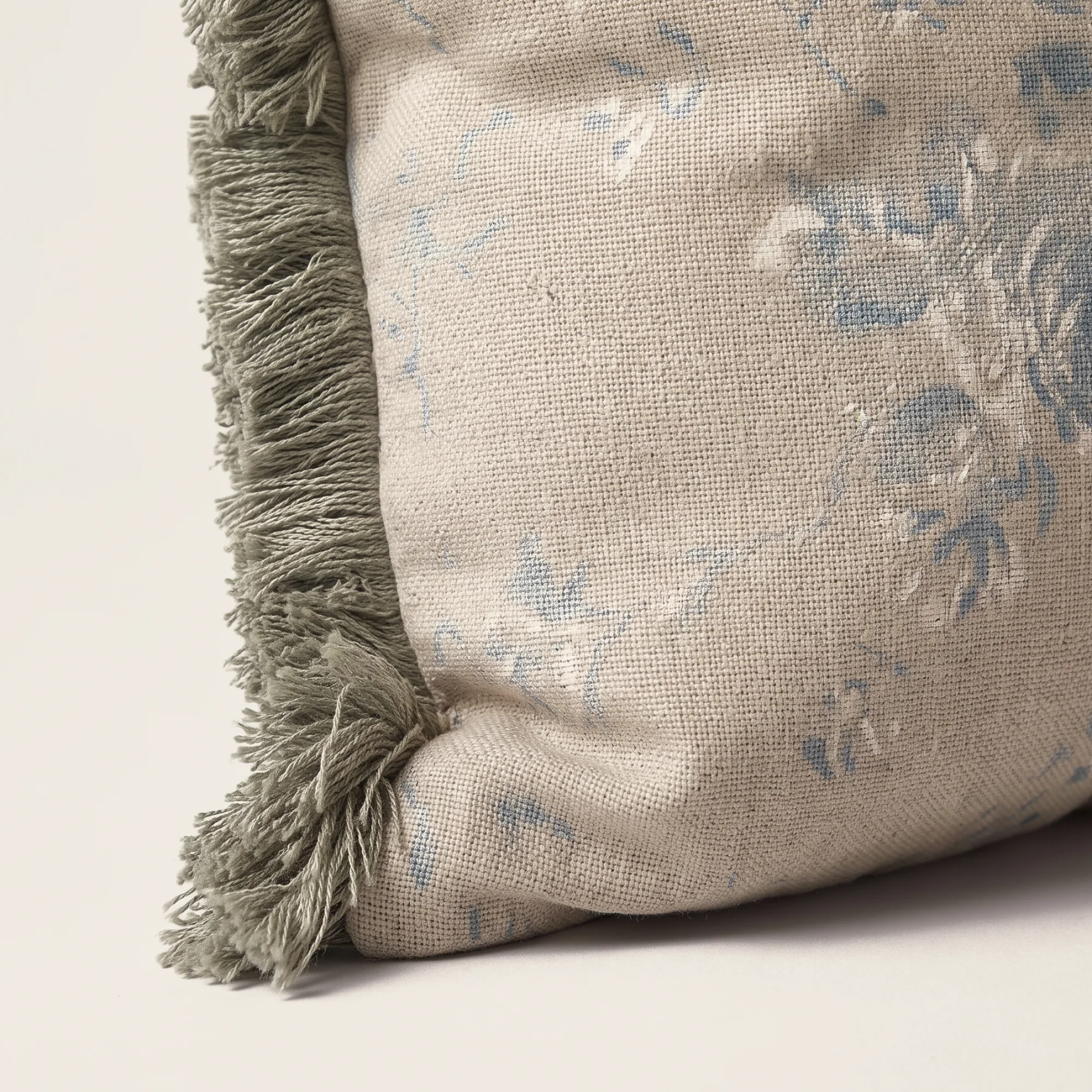 Rosebrook Floral Lumbar Throw Pillow 5 Close-up of the Rosebrook Floral Lumbar Throw Pillow corner showing the printed wool and sage-grey fringe